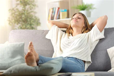 Woman relaxing at home after professional cleaning service
